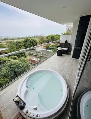 a bathroom with a bath tub on a balcony at 1 bedroom luxury apartment with private jaccuzi in Cartagena de Indias