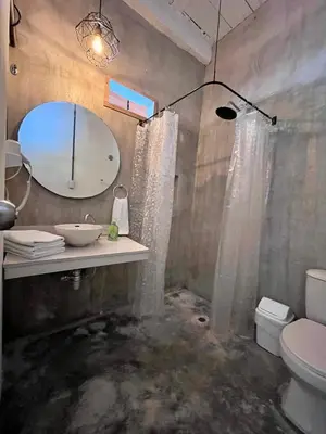 a bathroom with a sink and a toilet and a mirror at Calma Hospedaje in Turbaco