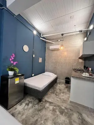 a bedroom with a bed in a blue room at Calma Hospedaje in Turbaco