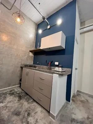 a kitchen with a sink and a blue wall at Calma Hospedaje in Turbaco