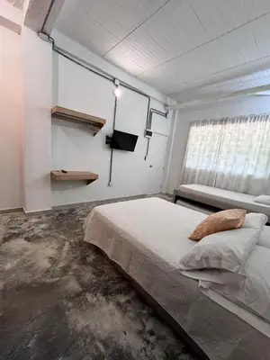 a bedroom with a bed and a tv in it at Calma Hospedaje in Turbaco