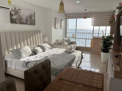 a bedroom with a bed and a couch in it at Apartamento Cristoforo Colombo in Cartagena de Indias