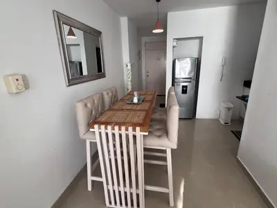 a kitchen with a table and chairs and a refrigerator at Apartamento Cristoforo Colombo in Cartagena de Indias