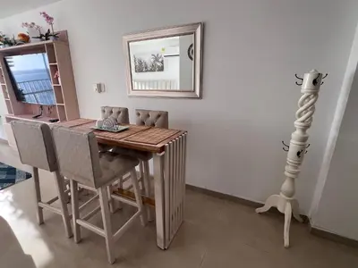 a dining room table with chairs and a mirror at Apartamento Cristoforo Colombo in Cartagena de Indias