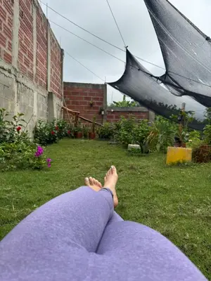 a woman laying on the grass under an umbrella at Casa Campestre DONDE MAMI ENA in Galapa