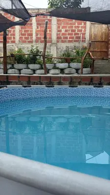a swimming pool with a bunch of rocks in front at Casa Campestre DONDE MAMI ENA in Galapa