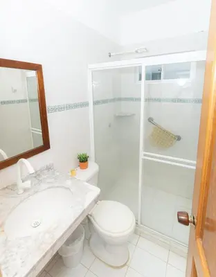 a bathroom with a shower and a toilet and a sink at Casa La Altamar in Coveñas