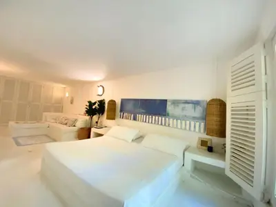 a white bedroom with a bed and a couch at Apartment in the Historical Center of Cartagena in Cartagena de Indias