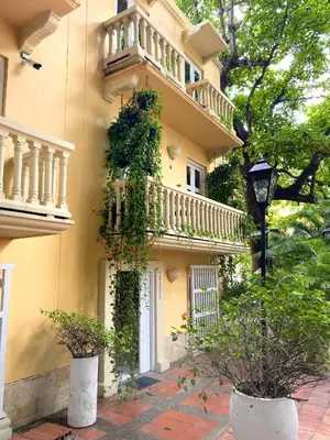 a building with a balcony and plants on it at Apartment in the Historical Center of Cartagena in Cartagena de Indias