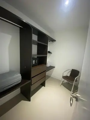 a room with a black cabinet and a chair at Luxury Ocean View - Bocagrande in Cartagena de Indias