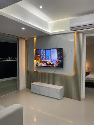 a living room with a tv on a wall at Luxury Ocean View - Bocagrande in Cartagena de Indias