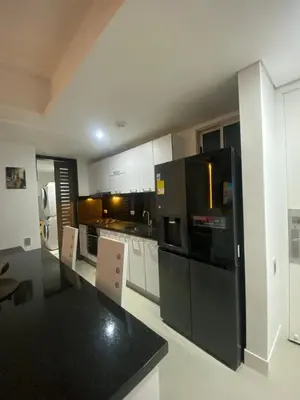 a large kitchen with black appliances and white cabinets at Luxury Ocean View - Bocagrande in Cartagena de Indias
