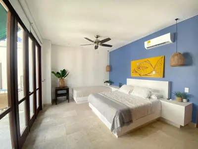 a bedroom with a bed and a blue wall at Apartamento en el centro historico de Cartagena in Cartagena de Indias