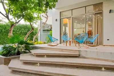 a group of blue chairs sitting on the porch of a house at Casa BaruGrande in Cartagena de Indias