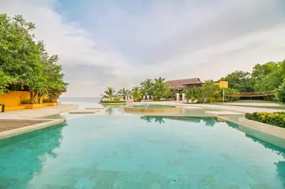 a swimming pool with a view of the ocean at Casa BaruGrande in Cartagena de Indias