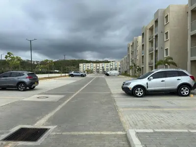 two cars parked in a parking lot next to buildings at Encanto de Serena in Manzanillo del Mar