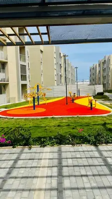a playground in front of a building with a red and yellow at Encanto de Serena in Manzanillo del Mar