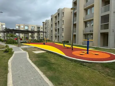a park with benches in front of a building at Encanto de Serena in Manzanillo del Mar