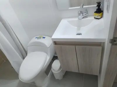 a bathroom with a white toilet and a sink at Encanto de Serena in Manzanillo del Mar
