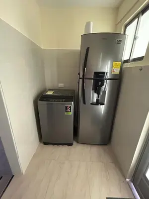 a refrigerator and a trash can in a room at acogedor aparta estudio in Cartagena de Indias