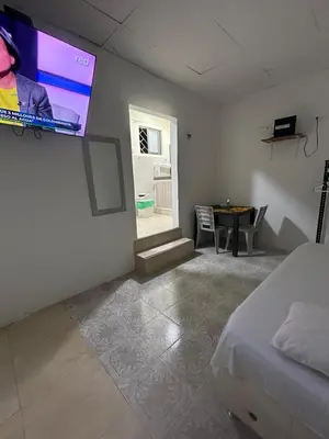 a bedroom with a bed and a tv on the wall at acogedor aparta estudio in Cartagena de Indias