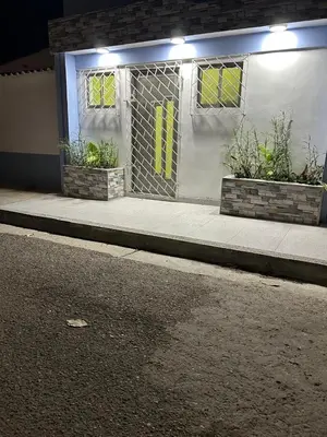 a white building with two windows and a street at acogedor aparta estudio in Cartagena de Indias