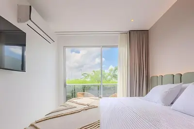 a bedroom with a bed and a large window at 1 k Baia Kristal lujoso y nuevo 2 alcobas Prive 2 in Cartagena de Indias