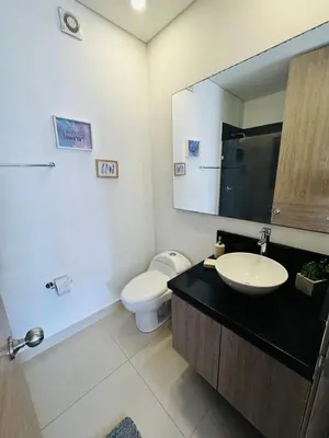 a bathroom with a sink and a toilet and a mirror at Vista Preciosa desde el piso 23 Apartamento frente al mar in Cartagena de Indias