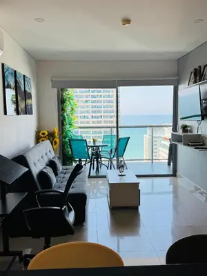 a living room with a couch and a table at Vista Preciosa desde el piso 23 Apartamento frente al mar in Cartagena de Indias