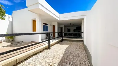 a white house with white walls and a balcony at Habitación Manglares 102 in Coveñas
