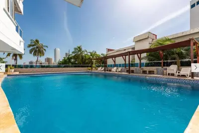 a large blue swimming pool in a building at Cartagena apartamento tipo loft in Cartagena de Indias
