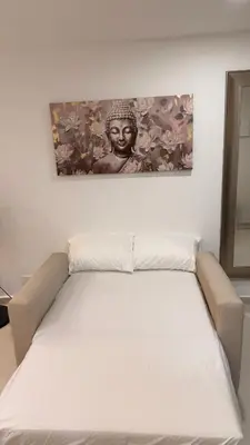 a bed in a room with a picture on the wall at Cartagena apartamento tipo loft in Cartagena de Indias