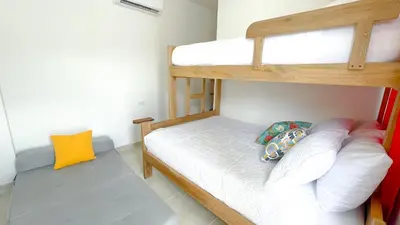 a small room with two bunk beds in it at Habitación Manglares 103 in Coveñas