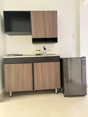 a kitchen with a counter and a sink and a microwave at Maru Apartamentos #4 in Cartagena de Indias