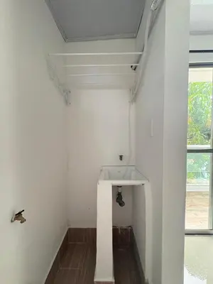 a white bathroom with a sink and a window at Maru Apartamentos #4 in Cartagena de Indias