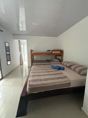 a large bed in a white room with at Maru Apartamentos #4 in Cartagena de Indias