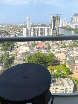 a view of a city from a balcony with a table at Cartagena Royal Residences 903 in Cartagena de Indias