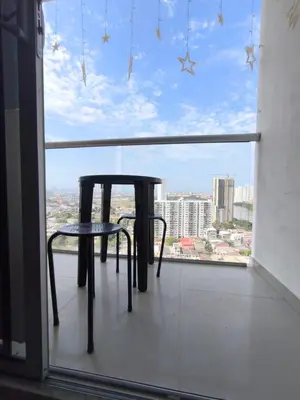 a table and chair in front of a large window at Cartagena Royal Residences 903 in Cartagena de Indias