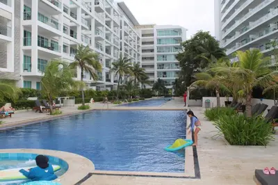 two children playing in a swimming pool at a resort at Espectacular apartamento morros 3 in Cartagena de Indias