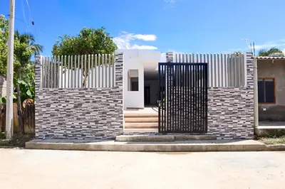 a house with a gate in front of it at Habitacion Manglares 101 in Coveñas