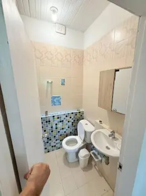 a bathroom with a toilet and a sink at Tropical Nomad Hub - Pool - Super Fast Wi-Fi in Santa Veronica
