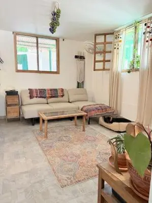 a living room with a couch and a table at Tropical Nomad Hub - Pool - Super Fast Wi-Fi in Santa Veronica