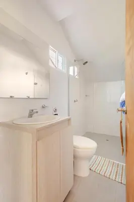 a white bathroom with a sink and a toilet at Vacation Home Escape & Villa with pool in El Morro