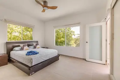 a bedroom with a bed and a ceiling fan at Vacation Home Escape & Villa with pool in El Morro
