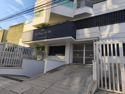 a building with a white fence in front of it at Apartamento con vista al mar en Bello Horizonte, Santa Marta in Santa Marta