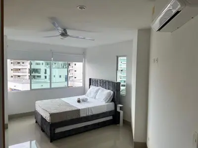 a bedroom with a bed and a ceiling fan at Apartamento con vista al mar en Bello Horizonte, Santa Marta in Santa Marta