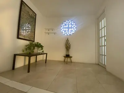 a room with a table and two lights on the wall at Casa Trinidad Getsemaní Hotel in Cartagena de Indias