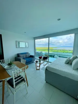 a bedroom with a bed and a living room at Apartamento en Cartagena cerca al hotel las Américas in Cartagena de Indias