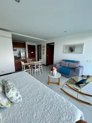 a bedroom with a large bed and a living room at Apartamento en Cartagena cerca al hotel las Américas in Cartagena de Indias