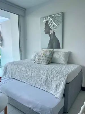 a bedroom with a bed with a bust of a woman at Apartamento en Cartagena cerca al hotel las Américas in Cartagena de Indias